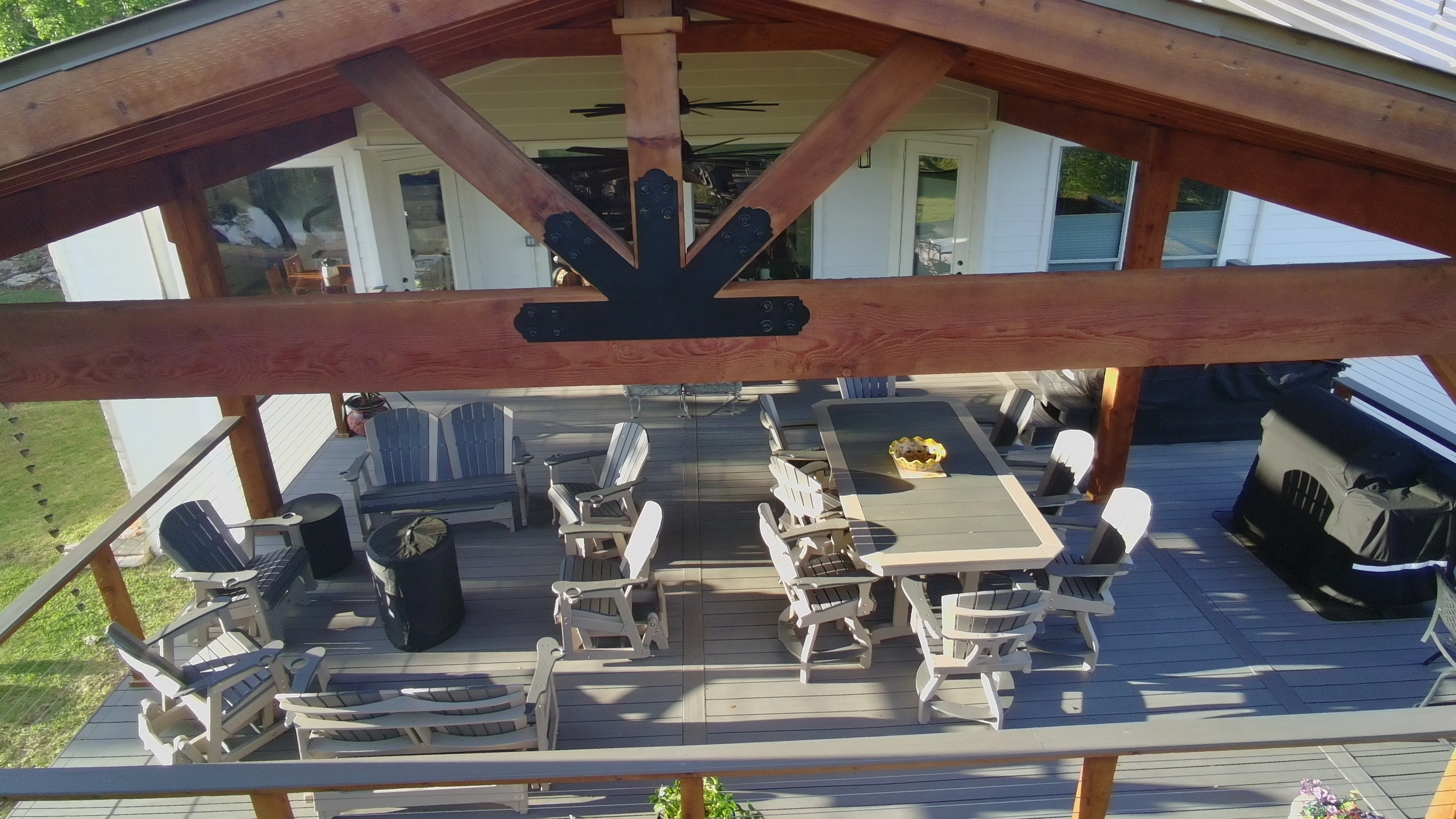 Detail of heavy-timber patio cover truss and outdoor dining on composite deck, San Antonio area
